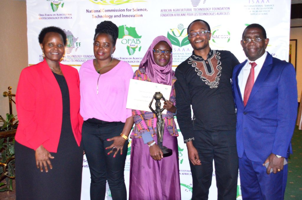 Dr. Karembu (far left), Chair OFAB-Kenya, and Dr. Dan Kiambi (far right), Alternate Chair, OFAB-Kenya, posing with the three winners at the media recognition award gala dinner, in September 2017.