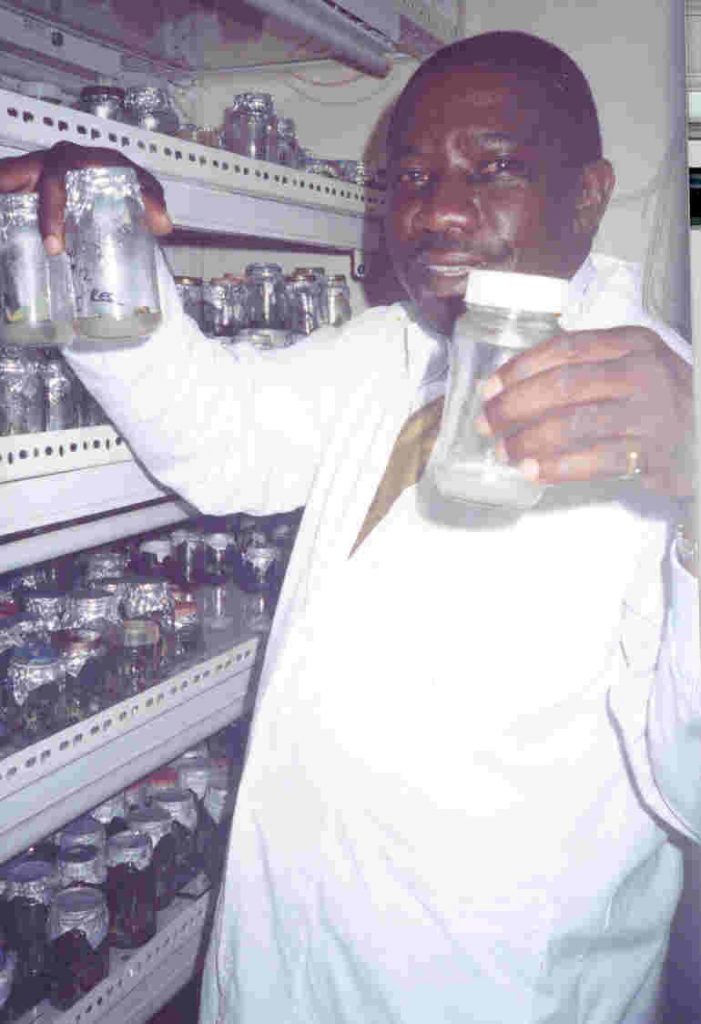 Erostus in his Kitchen lab with recycled jars