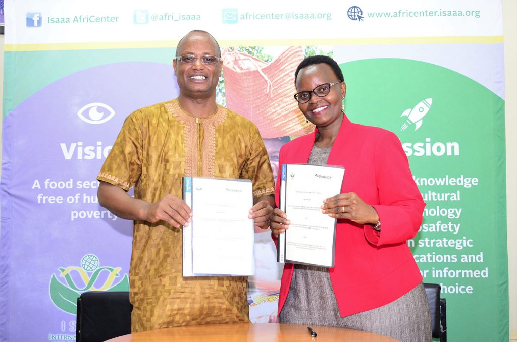 Prof. Jean Jacques Muhinda (left), Executive Director of the Association for Strengthening Agricultural Research in Eastern and Central Africa (ASARECA) and ISAAA AfriCenter Director Dr. Margaret Karembu during the signing of Memorandum of Agreement (MoA) between the two organizations. The MoA enables collaboration between the two parties in strengthening capacities for communication, policy advocacy and research on agricultural biotechnology and emerging biosciences in the region.